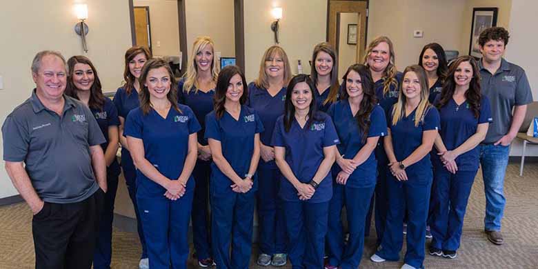 Team photo of dentists and staff members at Bayou Dental Group in Monroe, LA.