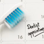 Reminder "Dentist appointment" in calendar with toothbrush.