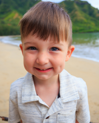 Toddler boy on a beach, portraing informaton on teeth grinding in children