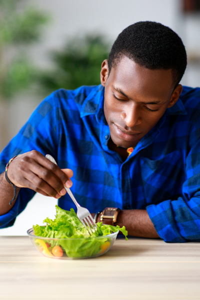 Young African American man eating a salad